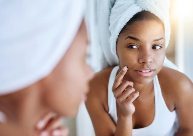 her-new-skincare-routine-is-showing-results-shot-young-woman-inspecting-her-skin-front-bathroom-mirror_590464-16515